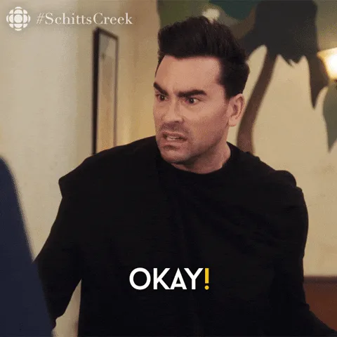 David Rose from Schitt’s Creek, hands raised, telling everyone to calm down.